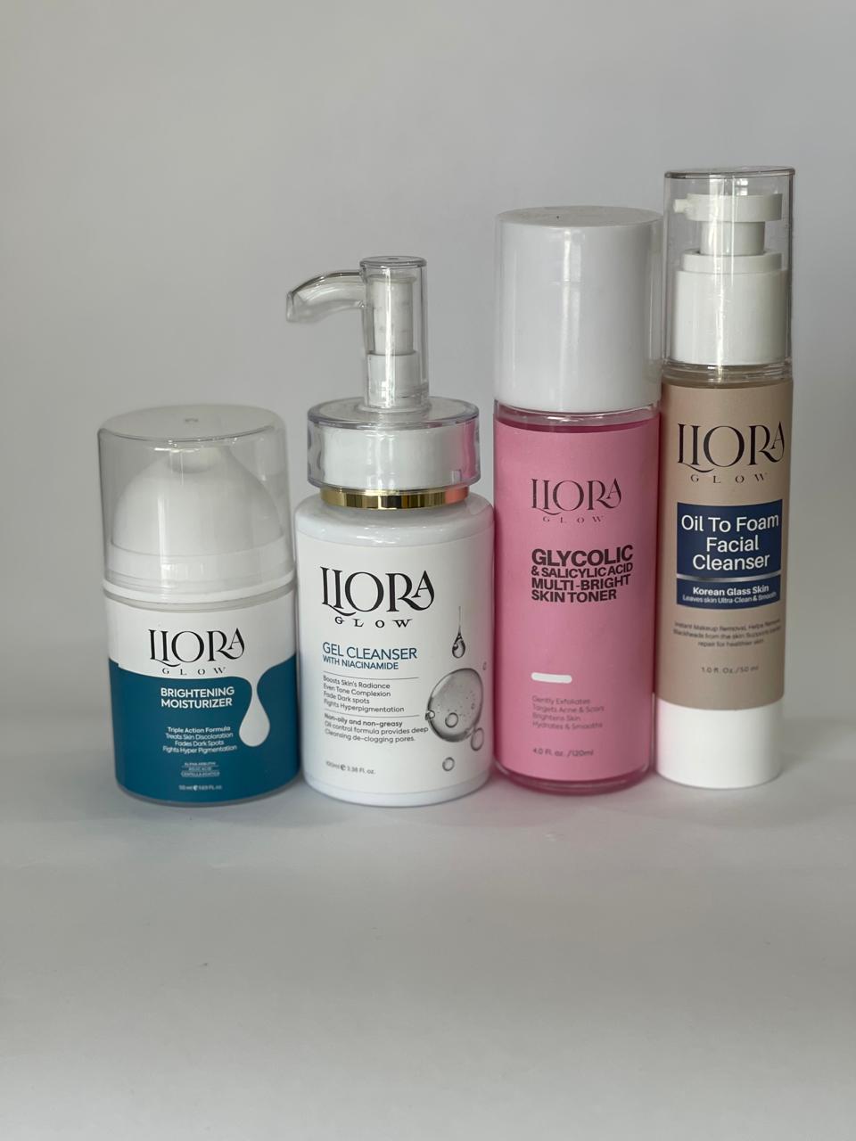 Set of five Llora Glow skincare products on a gray background