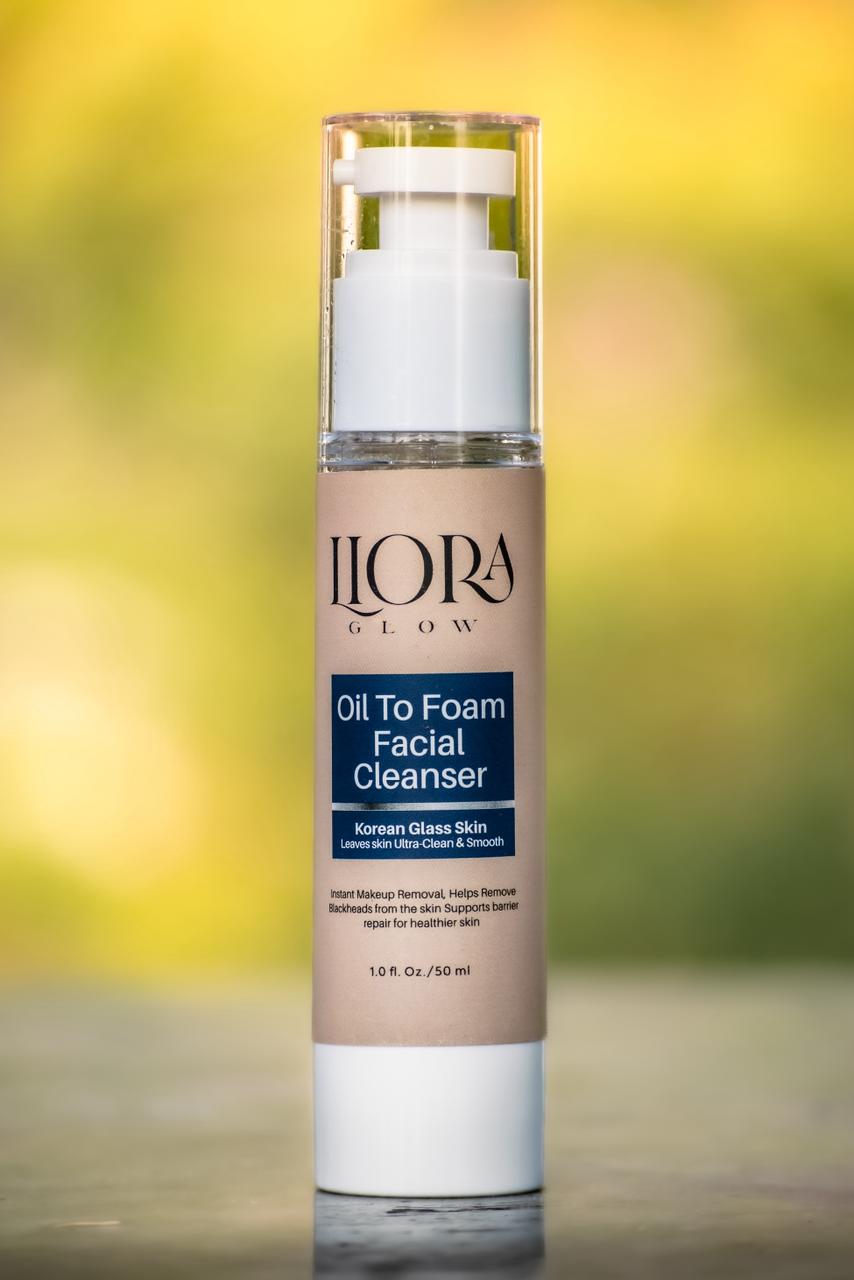 LLORA Oil To Foam Facial Cleanser bottle on a blurred natural background